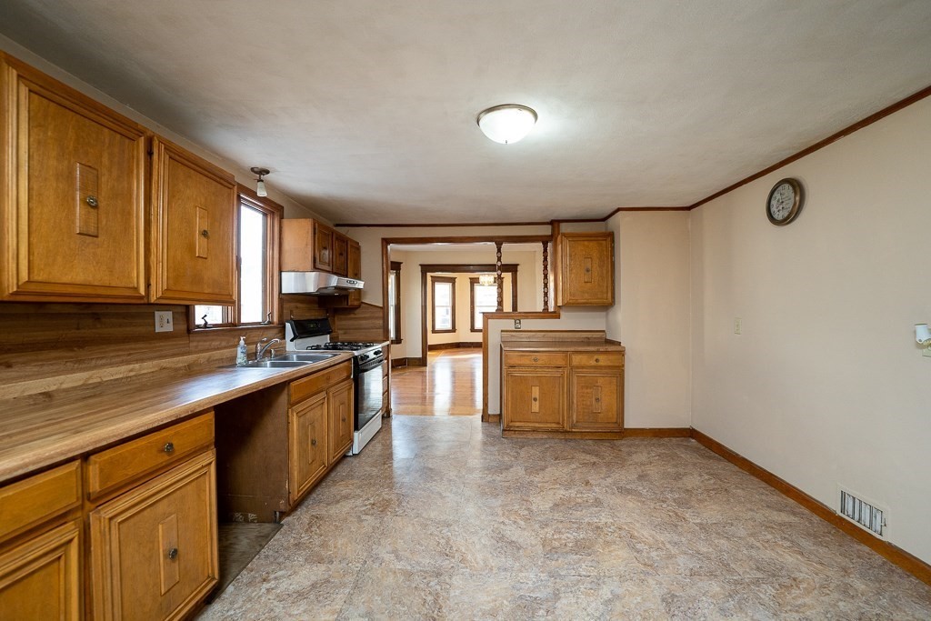 215 White Street Springfield, MA 01108 - Photo 4 of 33 a kitchen with granite countertop a stove and a sink