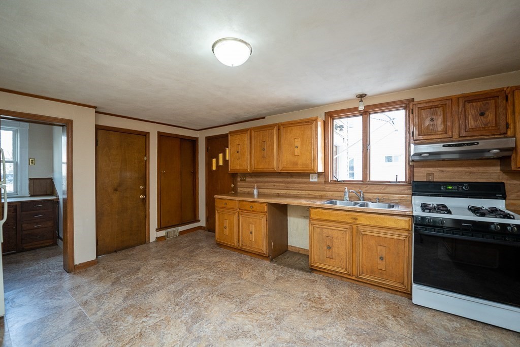 215 White Street Springfield, MA 01108 - Photo 6 of 33 a kitchen with stainless steel appliances granite countertop a stove and a refrigerator