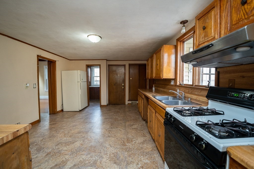 215 White Street Springfield, MA 01108 - Photo 7 of 33 a kitchen with stainless steel appliances granite countertop a stove and a sink