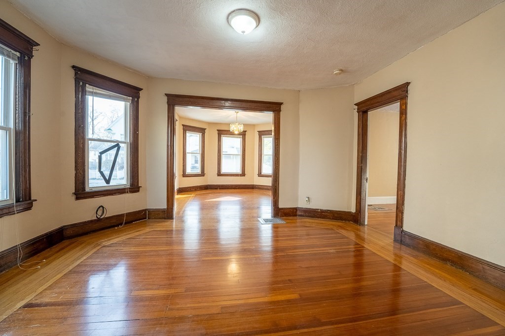 215 White Street Springfield, MA 01108 - Photo 9 of 33 an empty room with wooden floor and windows