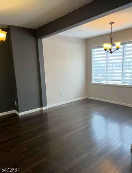 428 Brook Street, Unit 1 Linden, NJ 07036 - Photo 6 of 14 an empty room with wooden floor and windows