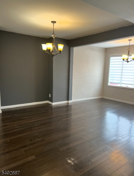 428 Brook Street, Unit 1 Linden, NJ 07036 - Photo 7 of 14 an empty room with wooden floor chandelier and windows