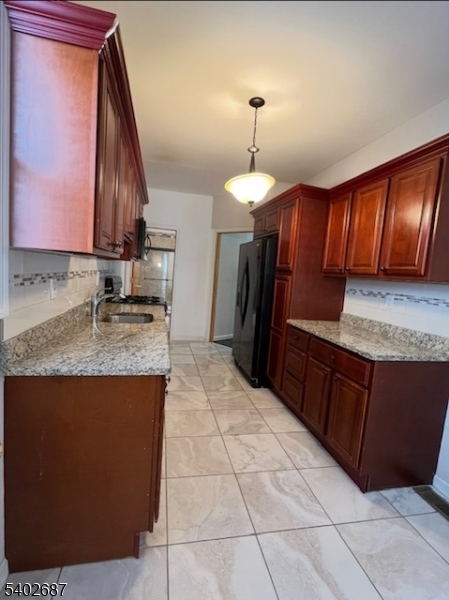 428 Brook Street, Unit 1 Linden, NJ 07036 - Photo 8 of 14 a kitchen with stainless steel appliances granite countertop a sink a stove and a refrigerator