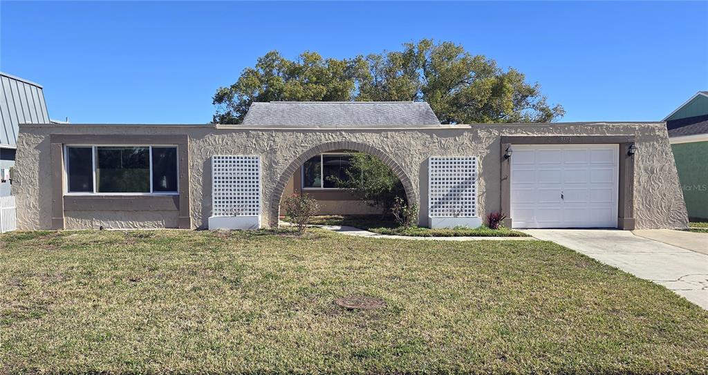 a front view of a house with a yard and garage