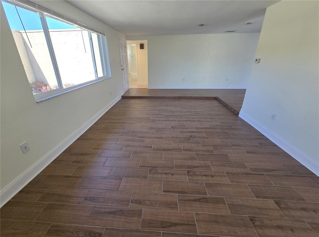 3604 Delta Place Holiday, FL 34691 - Photo 19 of 41 a view of an empty room with wooden floor and a window