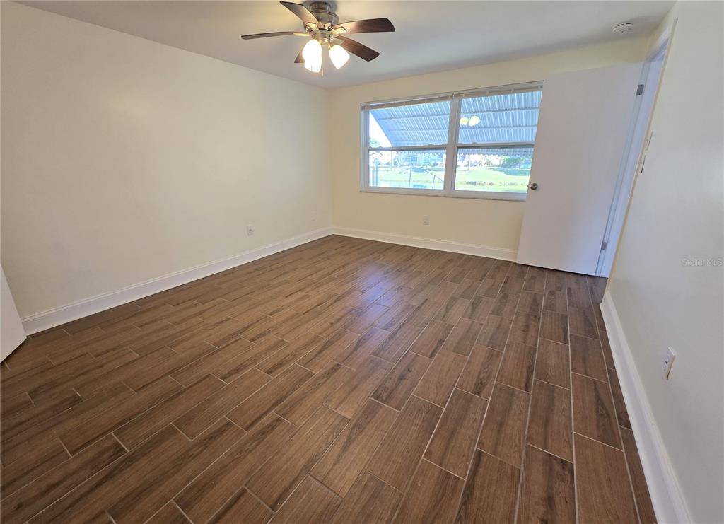 3604 Delta Place Holiday, FL 34691 - Photo 24 of 41 a view of an empty room with wooden floor and a window