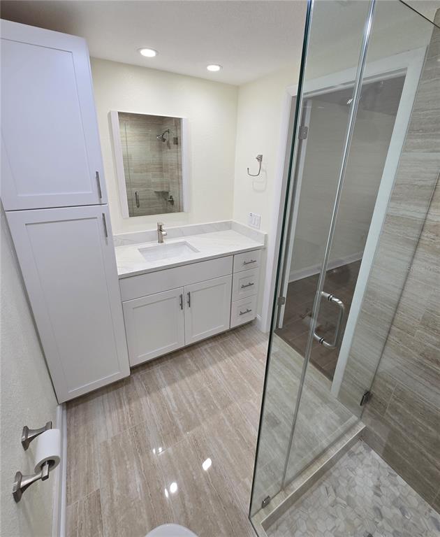 3604 Delta Place Holiday, FL 34691 - Photo 25 of 41 a bathroom with a sink a mirror and a shower