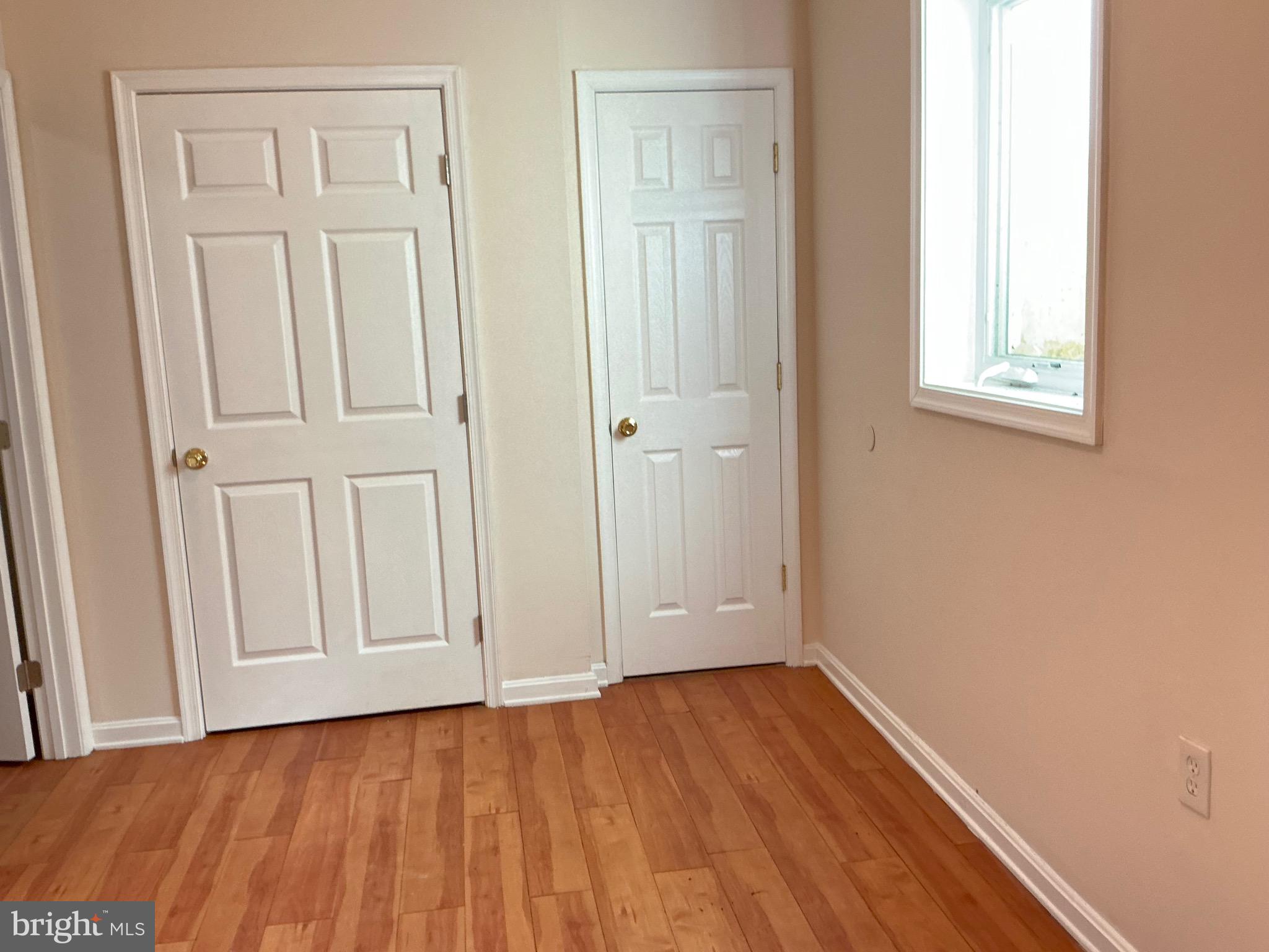 1671 Fort Davis Place Southeast Washington, DC 20020 - Photo 1 of 22 an empty room with wooden floor and closet area