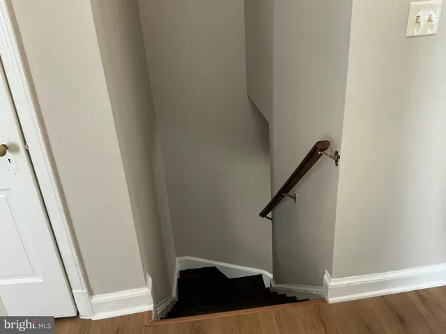 a view of entryway with stairs and wooden floor