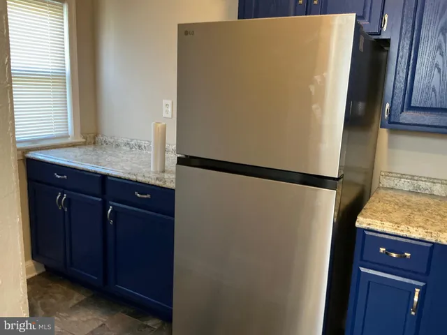a room with a refrigerator and window
