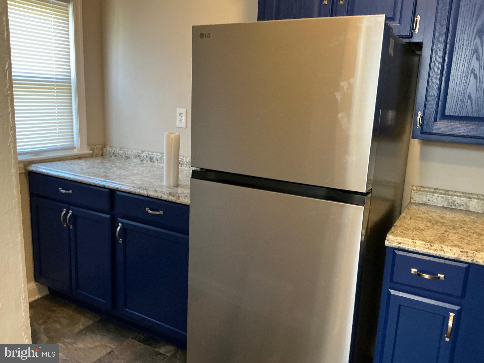 1671 Fort Davis Place Southeast Washington, DC 20020 - Photo 5 of 22 a room with a refrigerator and window
