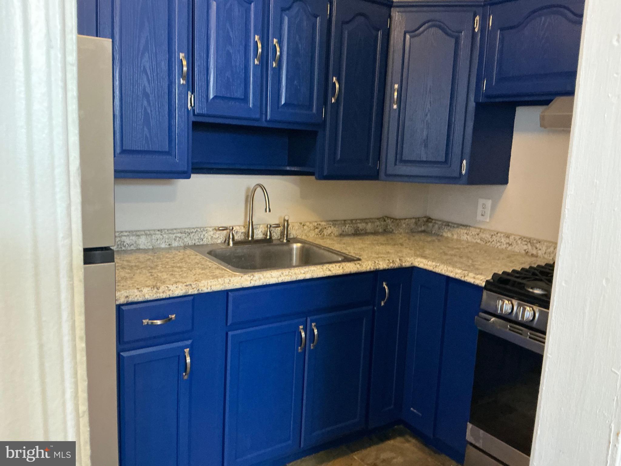 1671 Fort Davis Place Southeast Washington, DC 20020 - Photo 6 of 22 a kitchen with granite countertop wooden cabinets