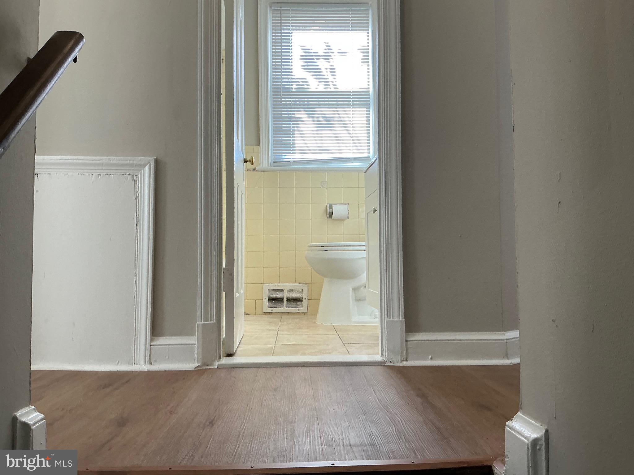 1671 Fort Davis Place Southeast Washington, DC 20020 - Photo 7 of 22 a view of an empty room with wooden floor and a window