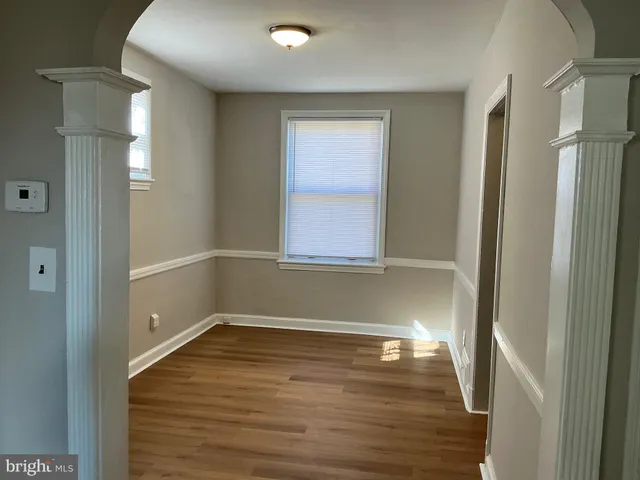 a view of a small space with wooden floor and entryway