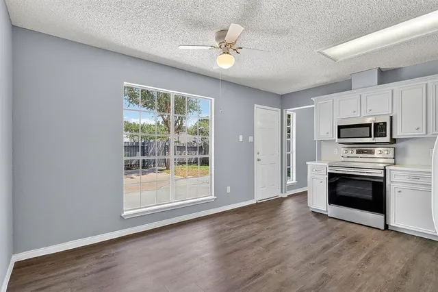 a view of kitchen with sink microwave and refrigerator
