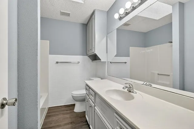 a bathroom with a sink toilet and a mirror