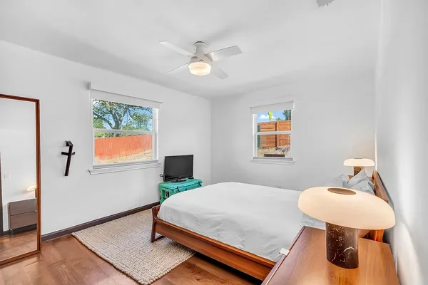 a bedroom with a bed and a lamp on table