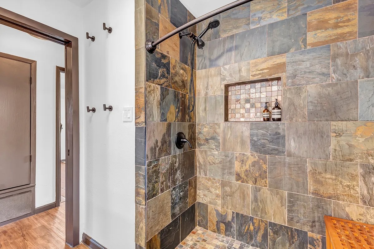 2307 Teri Road Austin, TX 78744 - Photo 18 of 28 Bathroom with tiled shower and baseboards