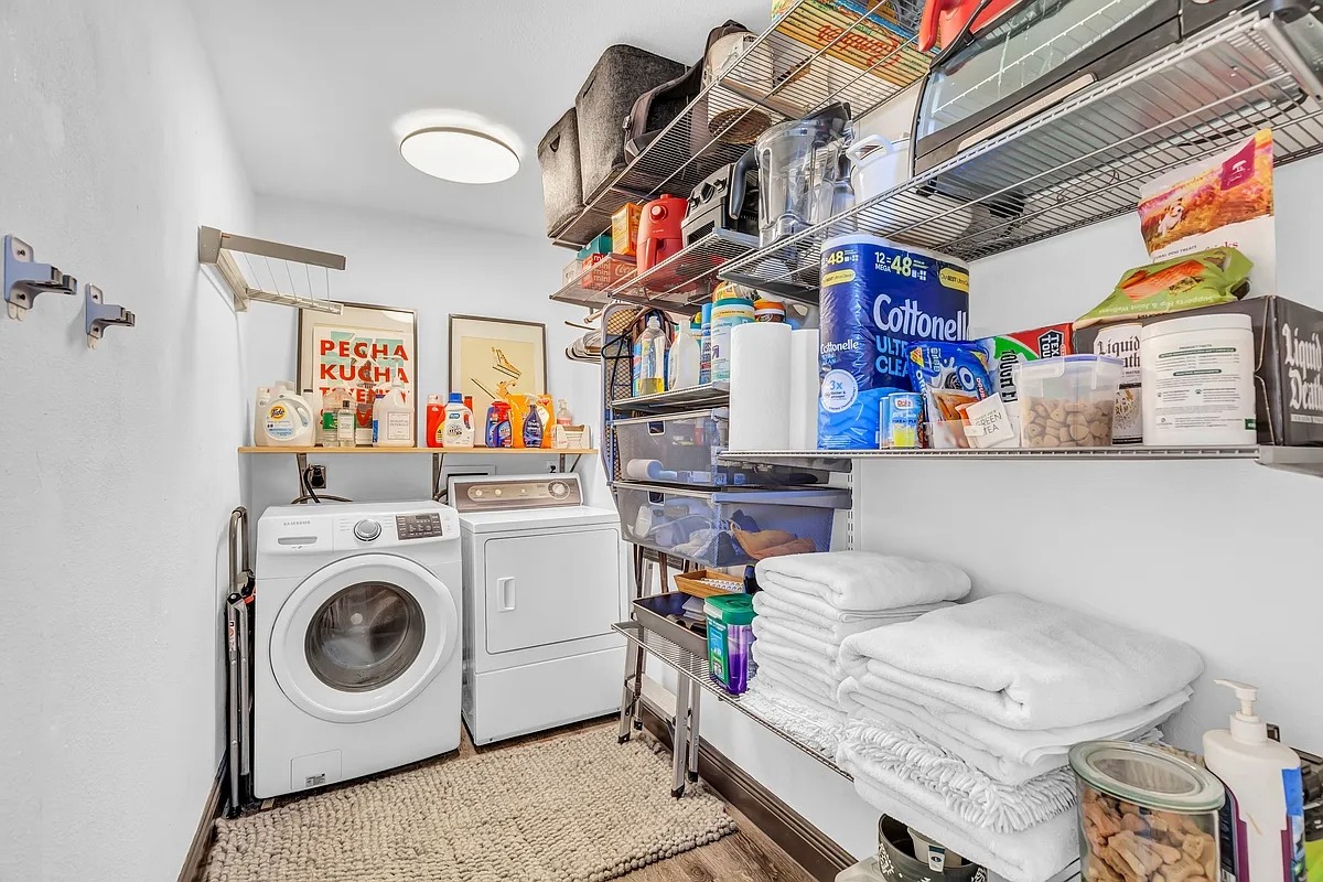 2307 Teri Road Austin, TX 78744 - Photo 24 of 28 Laundry area with washer and clothes dryer and light wood-style flooring