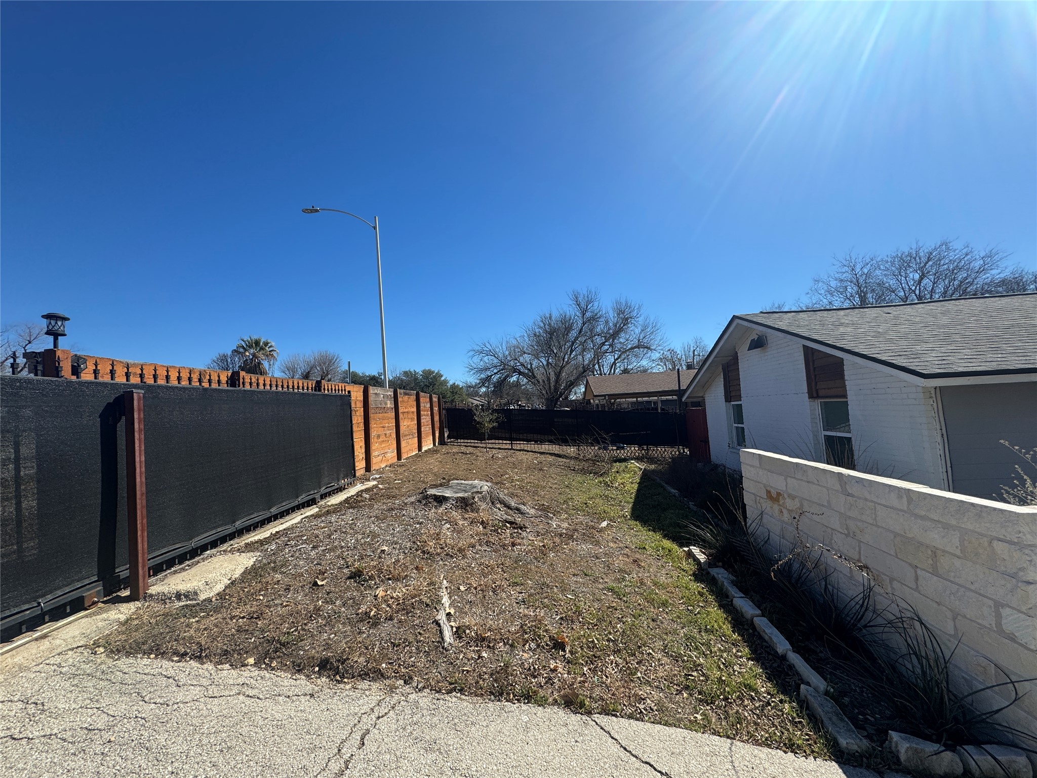 2307 Teri Road Austin, TX 78744 - Photo 27 of 28 Potential for additional parking area after removing tree stump.