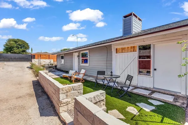 a view of a patio with couches chairs and potted plants