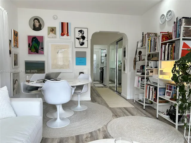 a living room with furniture and a book shelf