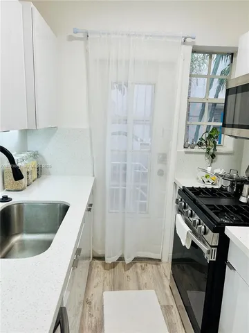 a kitchen that has a sink and a stove