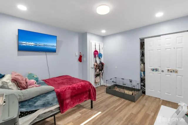 a bedroom with a bed and a flat screen tv