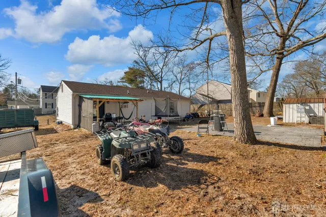 a view of a house with backyard and sitting area