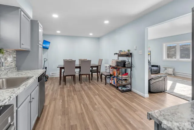a living room with furniture and wooden floors