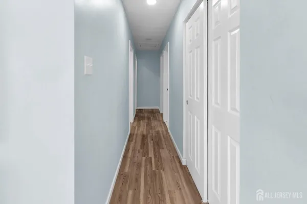 a view of a hallway with wooden floor