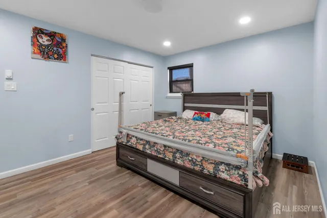 a bed sitting in a bedroom next to a window