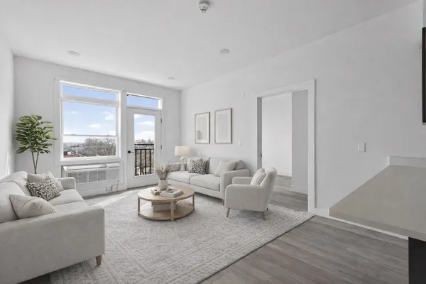 a living room with furniture and a large window