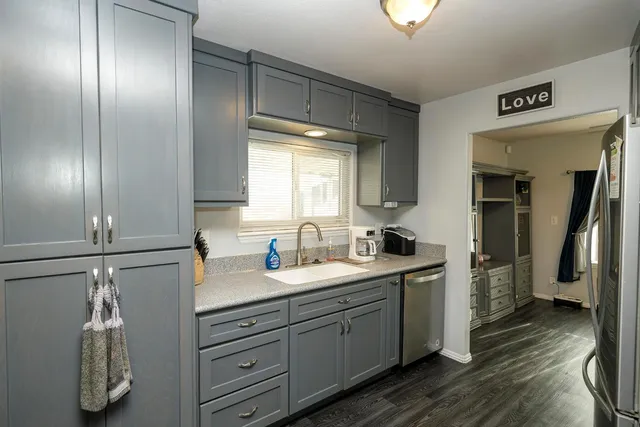 a en suite bathroom with a granite countertop sink and a mirror