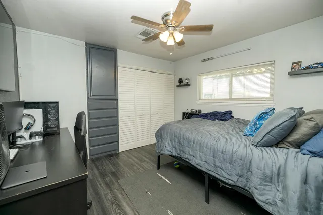 a bedroom with a bed and a desk