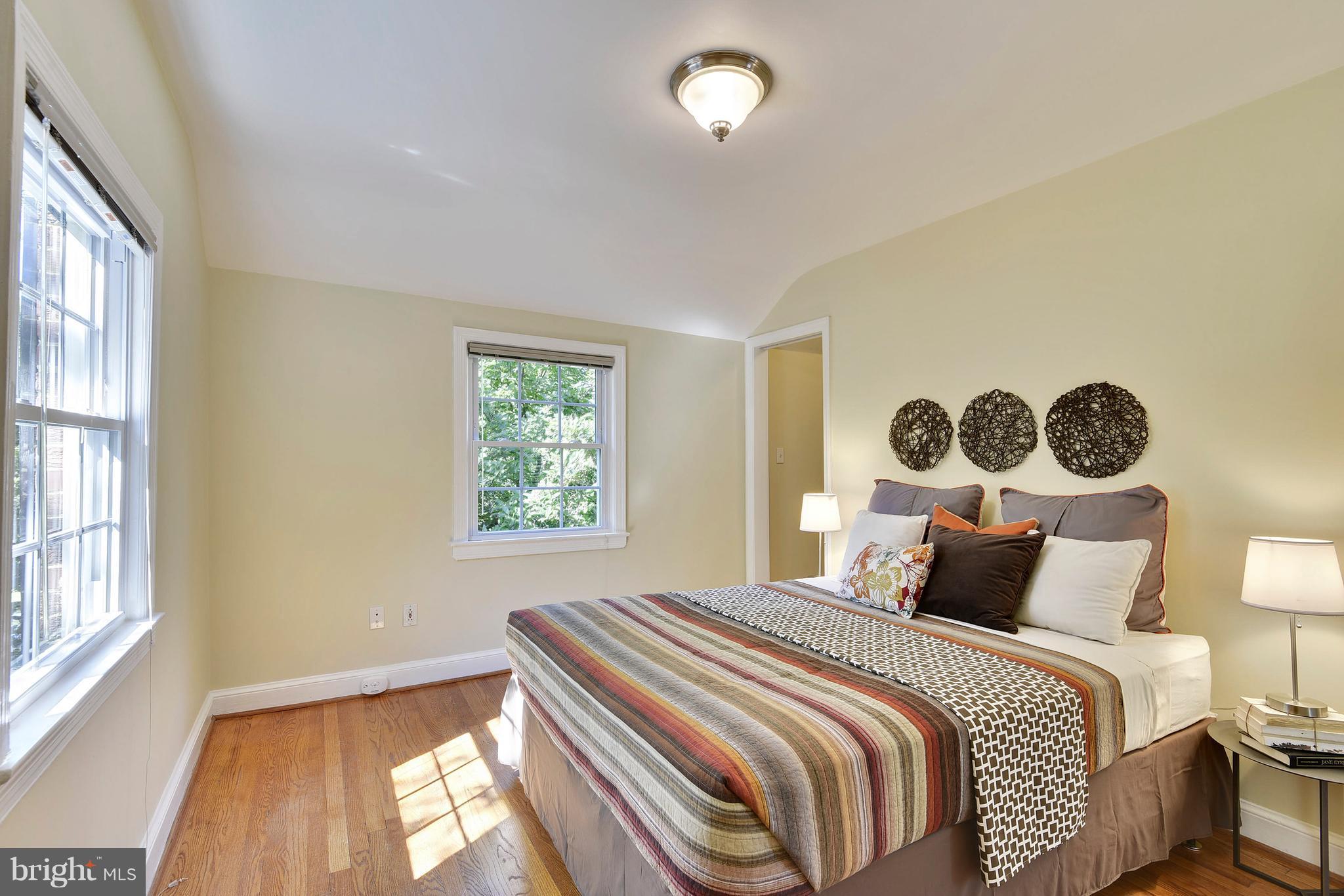 10001 Raynor Road Silver Spring, MD 20901 - Photo 12 of 30 a bedroom with a bed and wooden floor