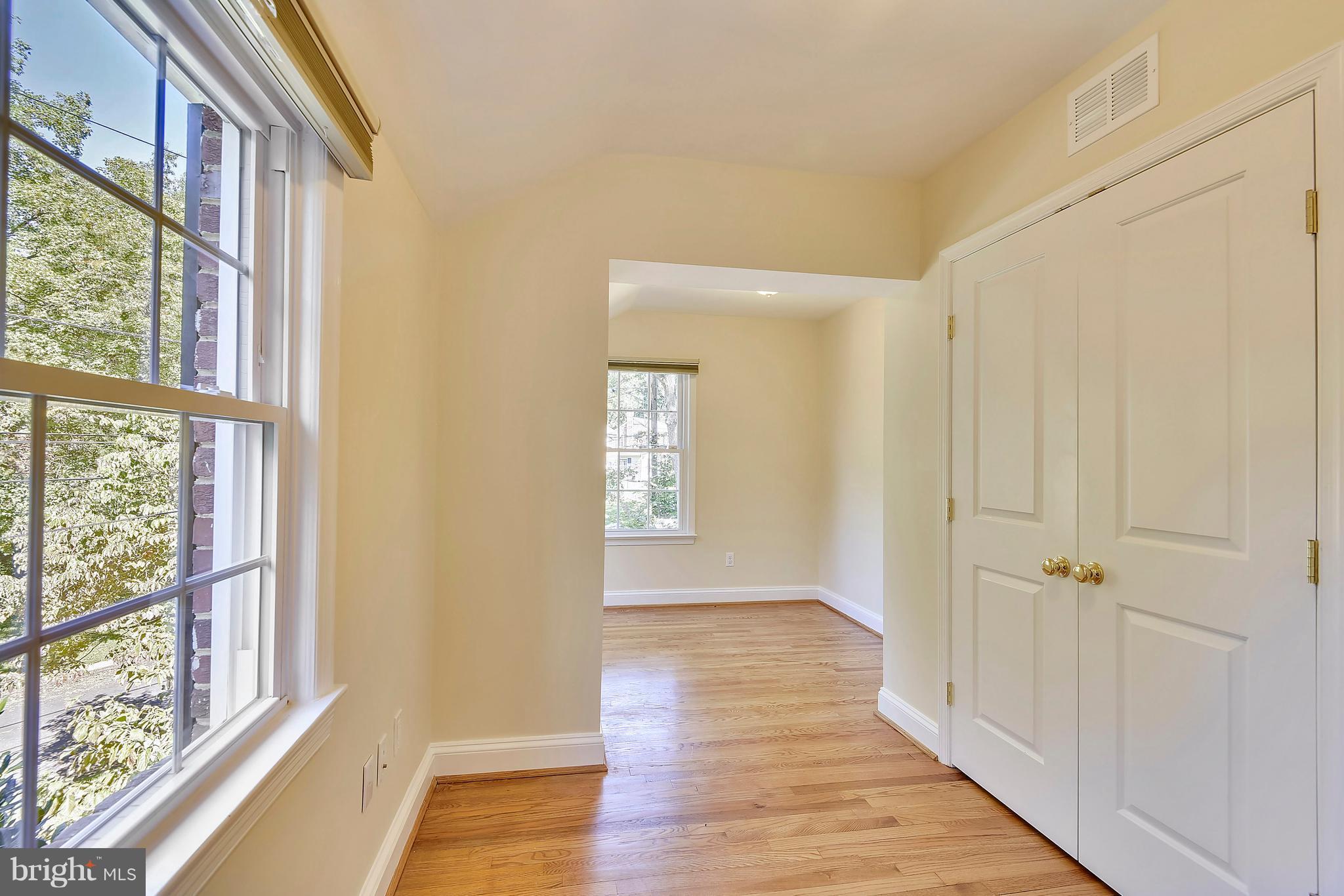 10001 Raynor Road Silver Spring, MD 20901 - Photo 17 of 30 a view of a hallway with wooden floor and windows