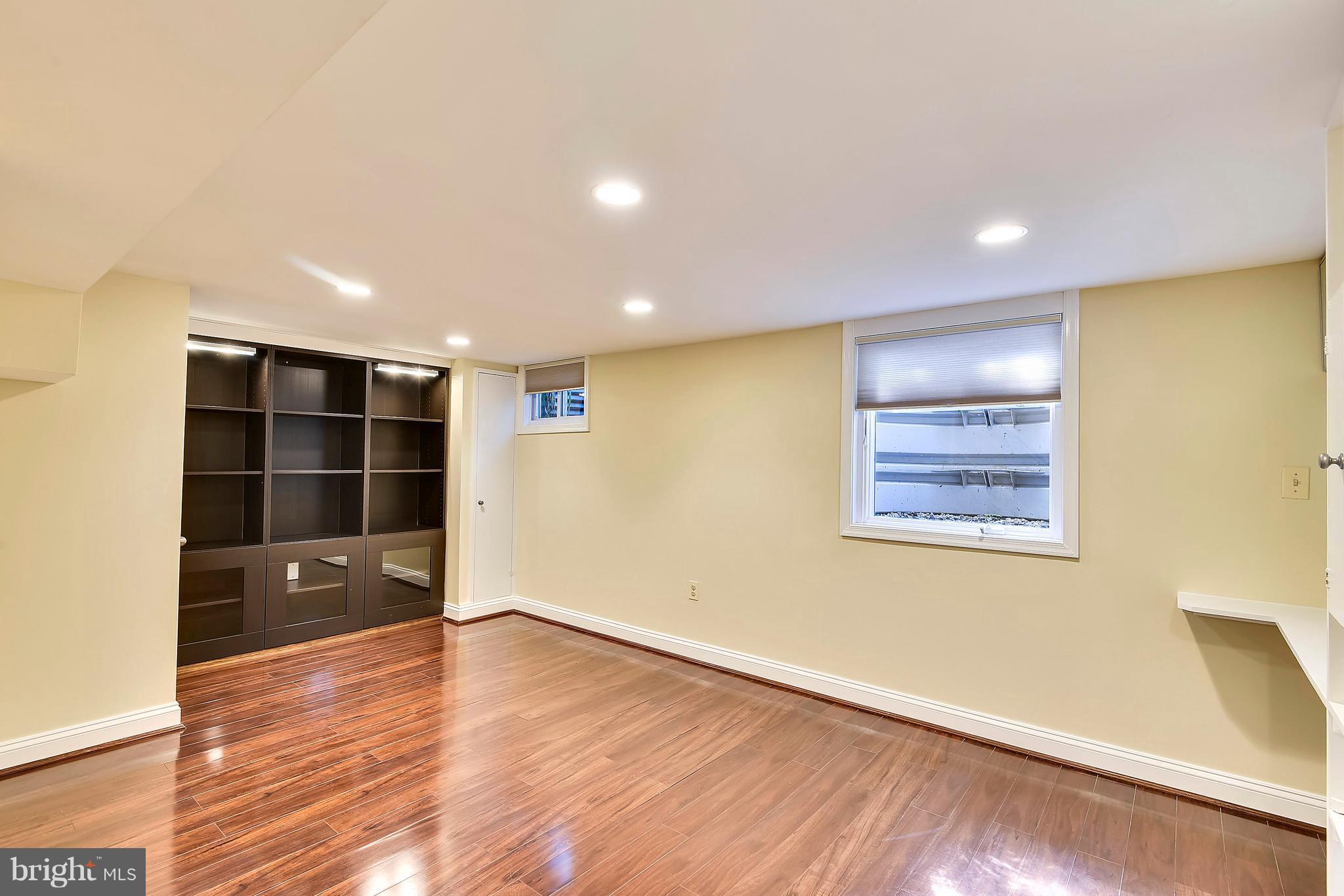 10001 Raynor Road Silver Spring, MD 20901 - Photo 19 of 30 an empty room with wooden floor and cabinet
