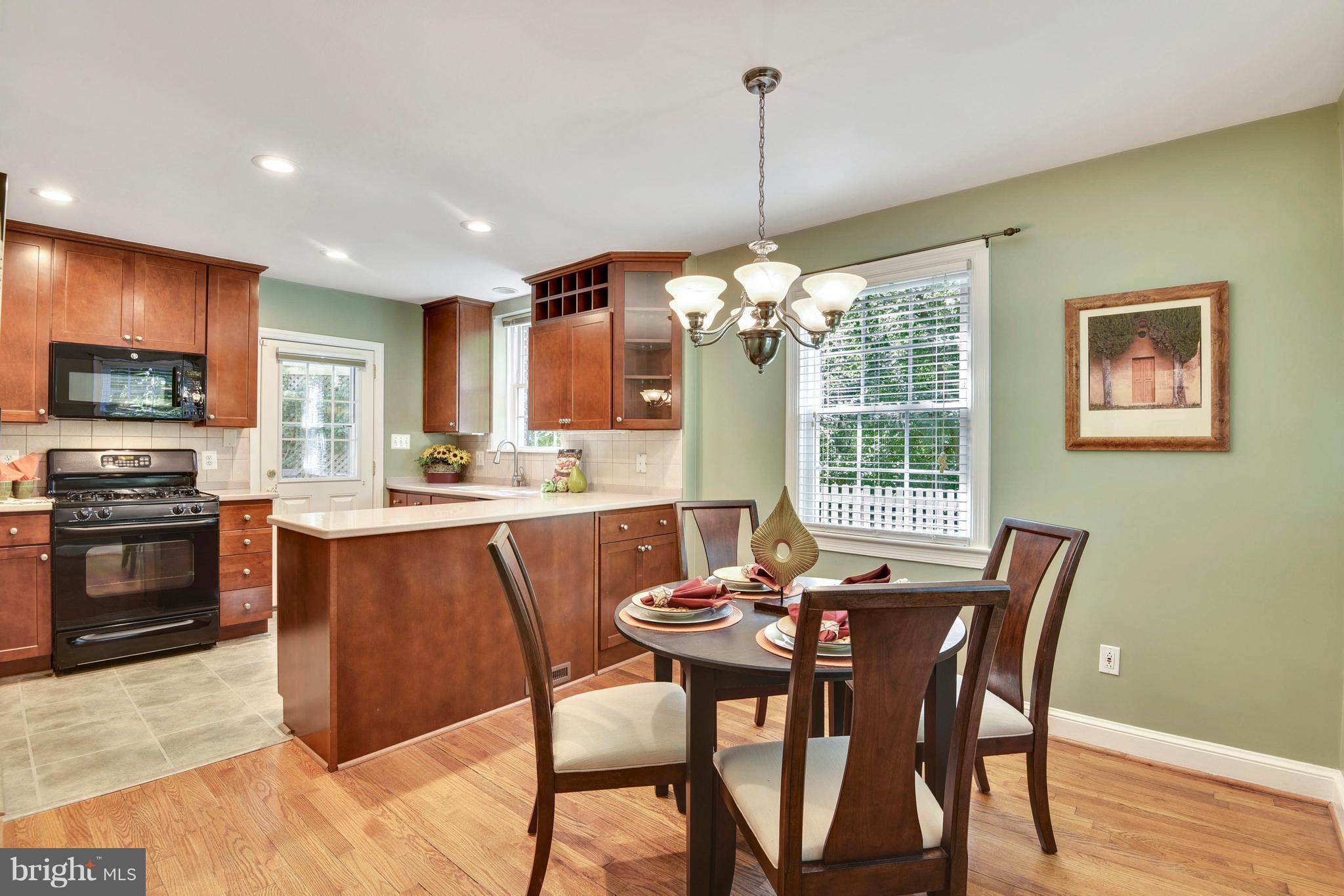 10001 Raynor Road Silver Spring, MD 20901 - Photo 7 of 30 a view of a dining room with furniture window and wooden floor