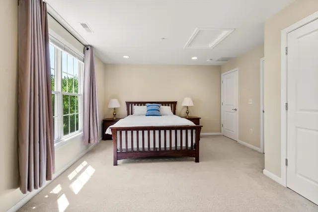 a spacious bedroom with a large bed and a large window