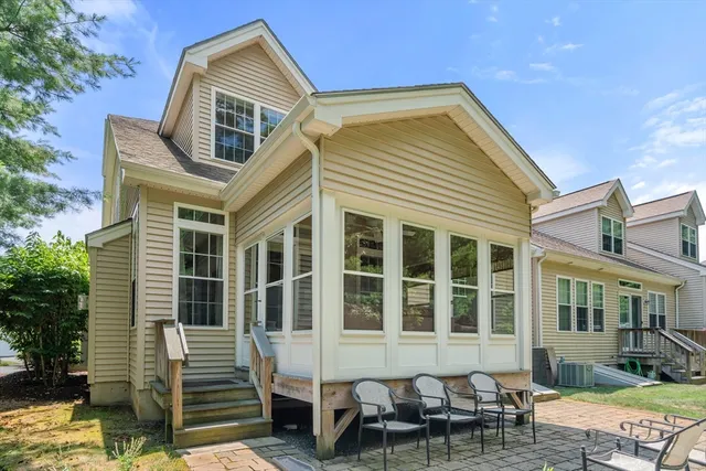 a front view of a house with outdoor seating and a lawn