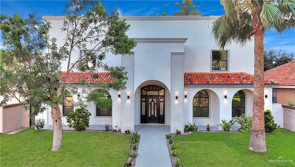 a front view of house with yard and green space