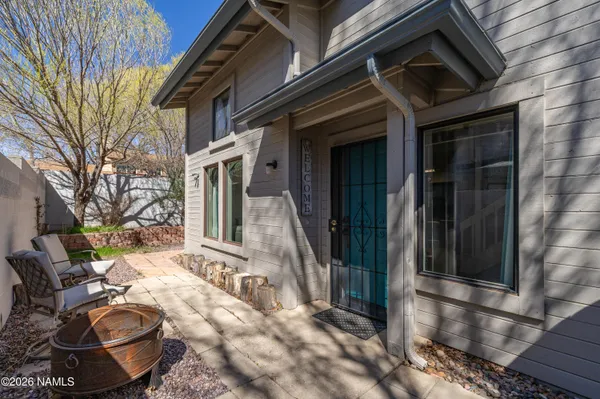 a backyard of a house with yard fire pit and furniture