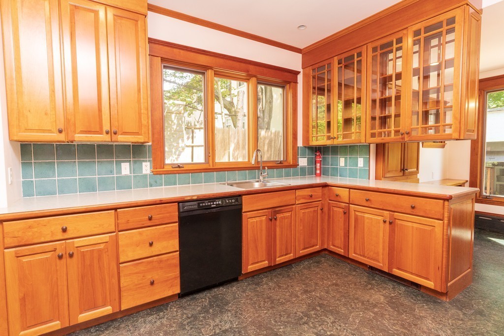 10 Downing Road Brookline, MA 02445 - Photo 8 of 13 a kitchen with granite countertop cabinets and large window