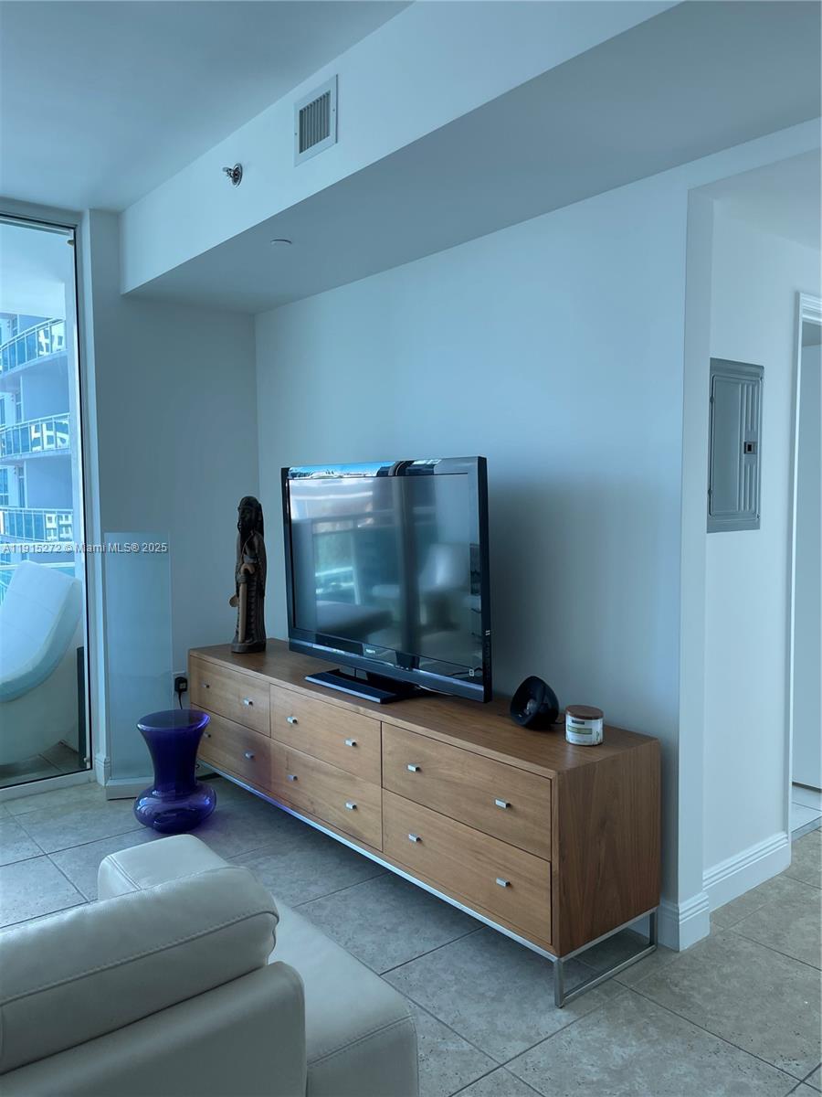 951 Brickell Avenue, Unit 1700 Miami, FL 33131 - Photo 11 of 17 a living room with furniture and a flat screen tv