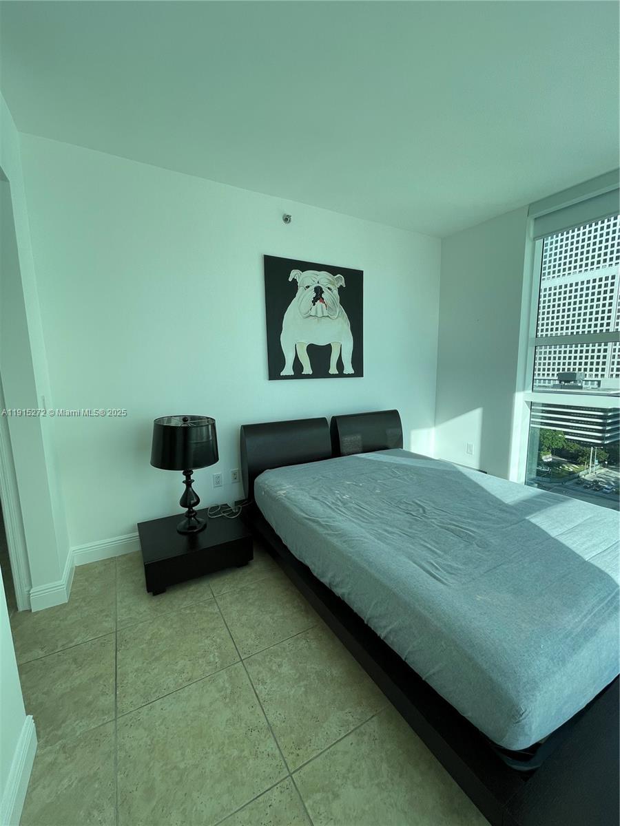 951 Brickell Avenue, Unit 1700 Miami, FL 33131 - Photo 15 of 17 a bedroom with a bed and window