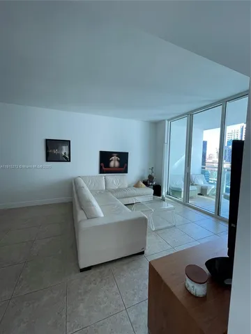 a view of a livingroom and dining room with furniture