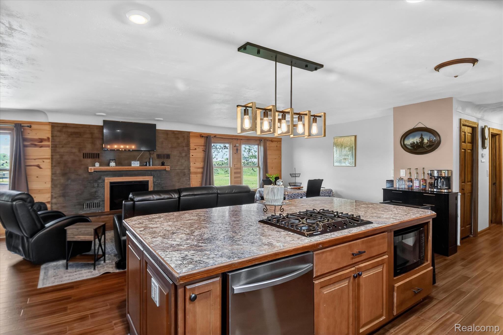 3949 West Burns Line Road Brown City, MI 48416 - Photo 21 of 70 Kitchen island with an integrated cooktop, stainless steel dishwasher, and built-in microwave