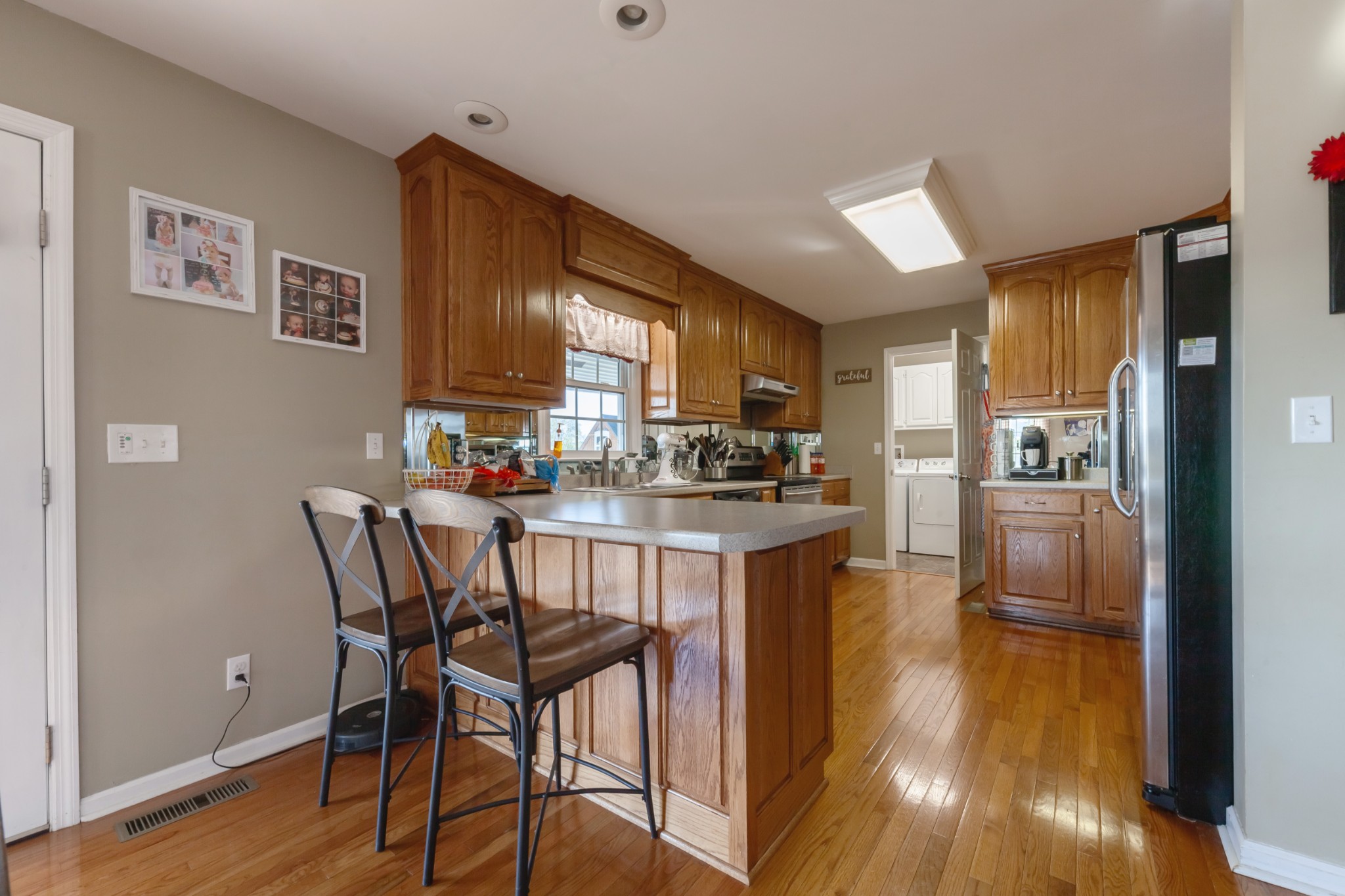 7055 Buford Station Road Lynnville, TN 38472 - Photo 14 of 34 a kitchen with a table chairs refrigerator and microwave