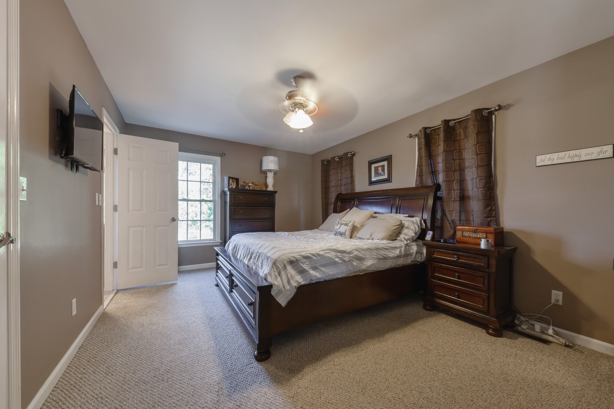 7055 Buford Station Road Lynnville, TN 38472 - Photo 18 of 34 a spacious bedroom with a bed and a chandelier